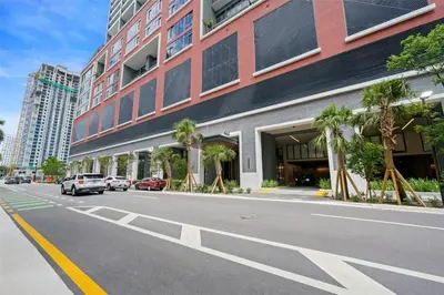a street with a building and cars parked on the street at Great Studio Pool Gym & Views in Miami