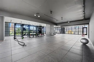 a large room with a gym with large windows at Lovely Studio - Pool & Gym in Miami