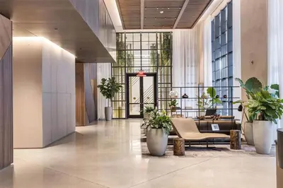 a lobby with a couch and plants in a building at Lovely Studio - Pool & Gym in Miami