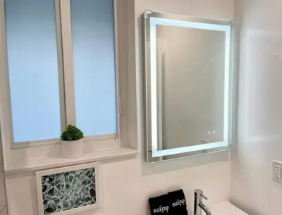 a bathroom with a mirror and a sink at Modern in heart of Hollywood in Hollywood