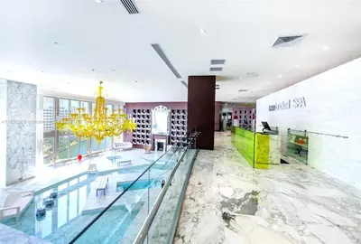 a lobby with a pool and a chandelier at Sky High Penthouse Corner 2BR 2BA Icon Brickell in Miami