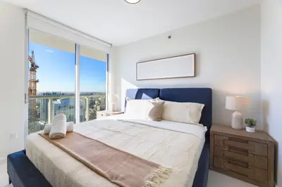 a bedroom with a large bed and a large window at Sky High Penthouse Corner 2BR 2BA Icon Brickell in Miami