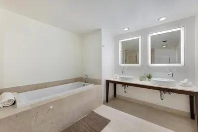 a bathroom with two sinks and a bath tub at Sky High Penthouse Corner 2BR 2BA Icon Brickell in Miami