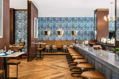 a restaurant with a bar with stools at Nautilus Sonesta Miami Beach in Miami Beach