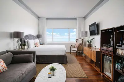 a hotel room with a bed and a couch at Nautilus Sonesta Miami Beach in Miami Beach
