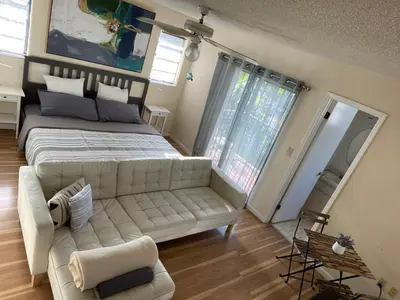 a living room with a large bed and a couch at Beautiful suite in the best location in Miami! in Miami