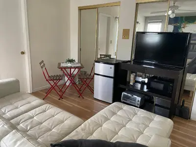 a living room with a couch and a flat screen tv at Beautiful suite in the best location in Miami! in Miami