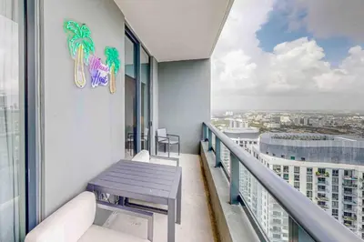 a balcony with a table and views of a city at Beachside Bliss Estate 4801 in Miami