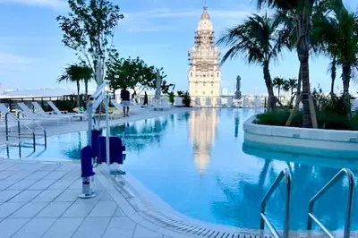 a large swimming pool with a building in the background at Beachside Bliss Estate 4801 in Miami