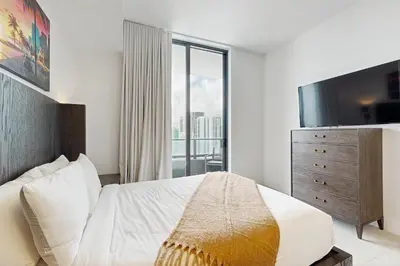 a bedroom with a bed and a large window at Beachside Bliss Estate 4801 in Miami