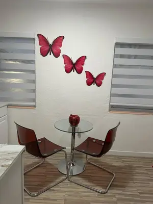 a table and chairs with butterflies on a wall at Villa Clara Red-Little Havana in Miami