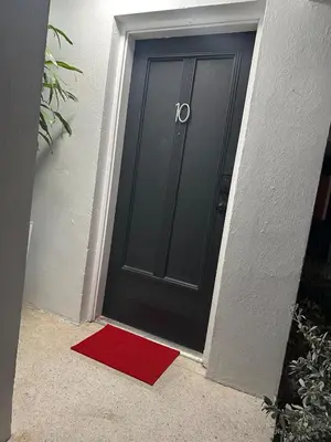 a black door with a red mat in front of it at Villa Clara Red-Little Havana in Miami