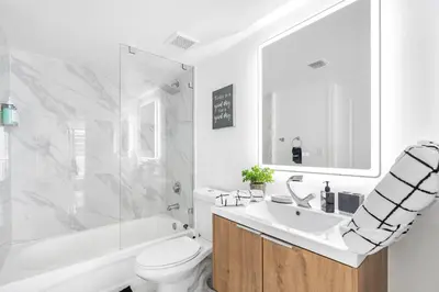 a bathroom with a sink and a tub and a toilet at Exclusivity & Relaxation Offered By Our Condo in Miami