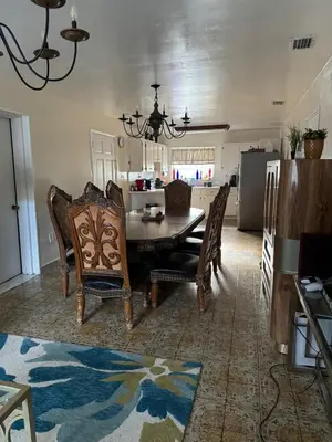 a dining room and kitchen with a table and chairs at Bed in 6-Bed Dormitory Room in Miami