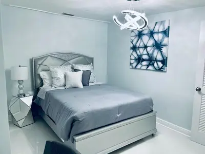a bedroom with a bed and a chandelier at Best Location!! in Miami