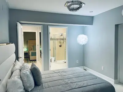 a bedroom with blue walls and a large bed at Best Location!! in Miami