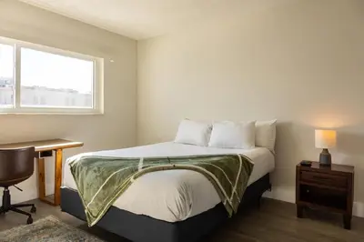 a bedroom with a bed and a desk and a window at 1BR with Kitchen Eastern Shores near Sunny Isles in North Miami Beach