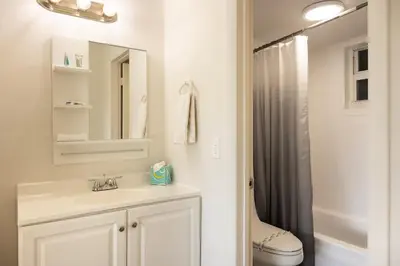 a white bathroom with a sink and a shower at 1BR with Kitchen Eastern Shores near Sunny Isles in North Miami Beach