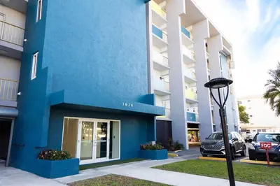 a blue building with cars parked in a parking lot at 1BR with Kitchen Eastern Shores near Sunny Isles in North Miami Beach