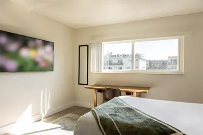 a bedroom with a bed and a desk and a window at 1BR with Kitchen Eastern Shores near Sunny Isles in North Miami Beach