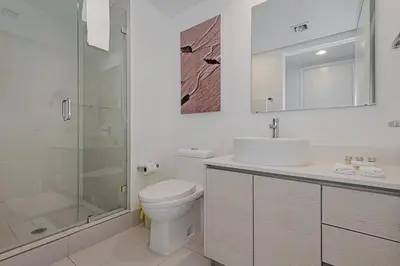 a bathroom with a toilet and a shower and a sink at Amazing Studio at Beachwalk on 15th Pool Gym Beach in Hallandale Beach