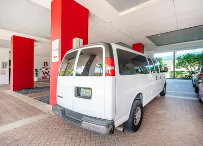 a small white van parked in a garage at Amazing Studio in Beachwalk with Pool and Beach in Hallandale Beach