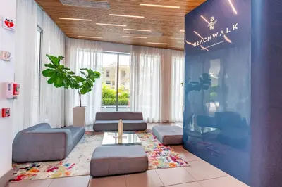 a lobby with a waiting room with couches and a table at Amazing Studio in Beachwalk with Pool and Beach in Hallandale Beach