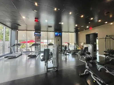 a gym with several treadms and cardio machines at 2 Bed 2 Bath Penthouse Amazing Views Beach Service in Hallandale Beach