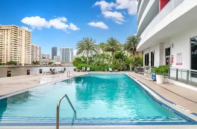 a swimming pool in the middle of a building at Amazing Studio at Beachwalk with Pool & Gym in Hallandale Beach