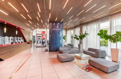 a lobby with couches and chairs in a building at 2BR & 2BA Oasis at Beachwalk in Hallandale Beach