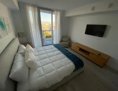 a bedroom with a large bed and a large window at 1 Bed & Kitchen at Beachwalk - Pool Gym Beach 22fl in Hallandale Beach