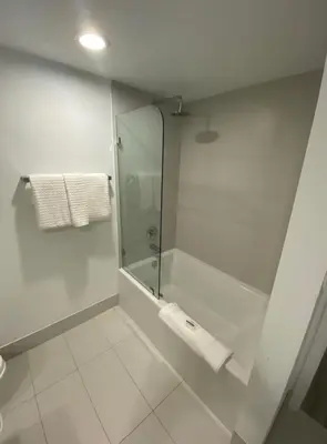 a bathroom with a shower with a glass door at 2 Bed 2 Bath Full Equiped Beachwalk Pool Gym 22 in Hallandale Beach