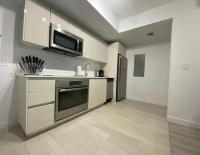 a kitchen with a stove and a microwave at 2 Bed 2 Bath Full Equiped Beachwalk Pool Gym 22 in Hallandale Beach