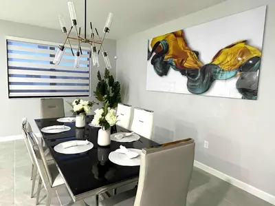 a dining room with a black table and chairs at Cozy house in Goulds