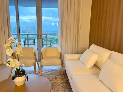 a living room with a couch and a table at Luxury Ocean Views Apt in Hallandale Beach in Hallandale Beach