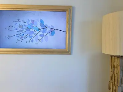 a painting of a branch on a wall next to a lamp at Luxury Ocean Views Apt in Hallandale Beach in Hallandale Beach