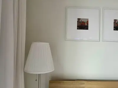 a table with a white lamp and some pictures at Luxury Ocean Views Apt in Hallandale Beach in Hallandale Beach