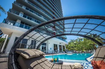 a resort with a swimming pool and a building at Luxury Ocean Views Apt in Hallandale Beach in Hallandale Beach