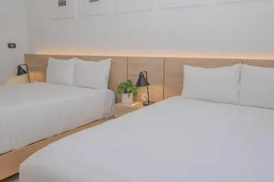 two beds in a hotel room with white pillows at Studio Luxury Ocean Views Apt in Hallandale Beach in Hallandale Beach