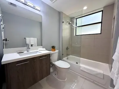a bathroom with a toilet and a sink and a shower at Bay Breeze Premium Apartments by Eskape Collection in Miami Beach
