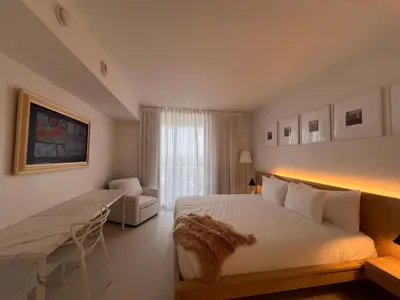 a bedroom with a bed and a desk and a couch at 2B 2B Luxury Ocean Views Apt in Hallandale Beach in Hallandale Beach