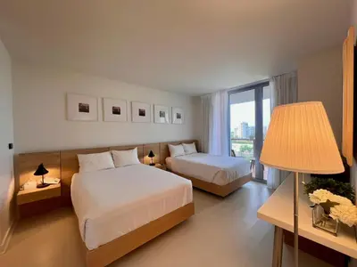 a hotel room with two beds and a window at 2B 2B Luxury Ocean Views Apt in Hallandale Beach in Hallandale Beach
