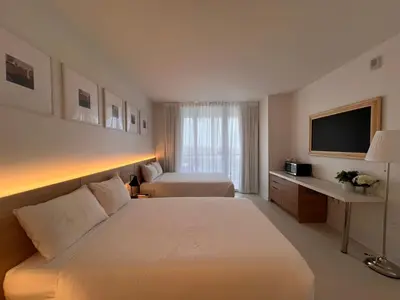 a hotel room with a bed and a television at 2B 2B Luxury Ocean Views Apt in Hallandale Beach in Hallandale Beach