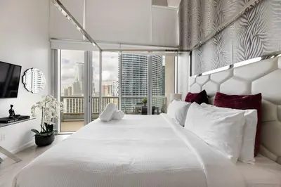 a bedroom with a large white bed with a large window at High Ceiling Exquisite 1BR 1BA ICON Brickell in Miami