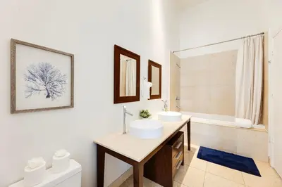 a bathroom with two sinks and a tub at High Ceiling Exquisite 1BR 1BA ICON Brickell in Miami