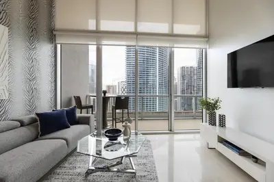 a living room with a couch and a large window at High Ceiling Exquisite 1BR 1BA ICON Brickell in Miami