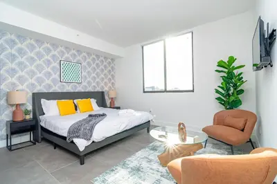 a bedroom with a bed and a chair at Urban Oasis in Miami Close to Bayside and Brickell with Free Parking in Miami
