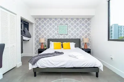 a bedroom with a bed with two yellow pillows at Urban Oasis in Miami Close to Bayside and Brickell with Free Parking in Miami