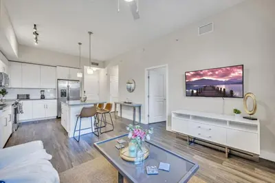 a kitchen and living room with a couch and a table at Trendy One Bedroom Getaway Steps from Biscayne in Miami