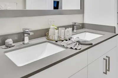 a bathroom with two sinks and two mirrors at Trendy One Bedroom Getaway Steps from Biscayne in Miami